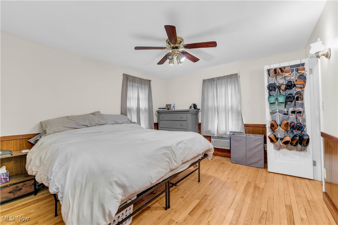 3729 Grosvenor Road Cleveland, OH 44118 - Photo 29 of 39 Bedroom featuring light wood-type flooring, a wainscoted wall, and ceiling fan