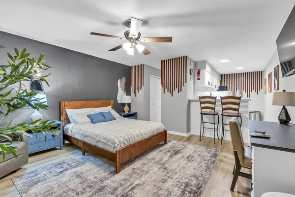 a bedroom with a bed and a chandelier