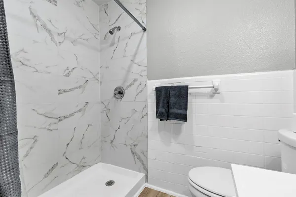 a bathroom with a toilet and shower