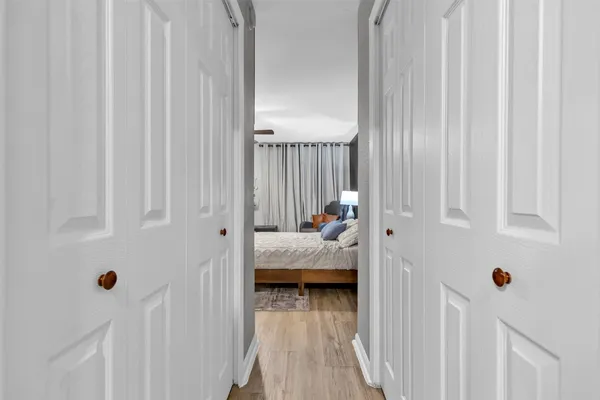 a view of bedroom with furniture and wooden floor