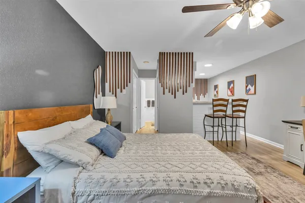 a bedroom with a bed and a chandelier