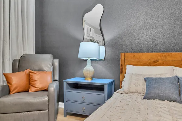 a bedroom with a bed and a lamp