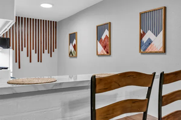 a bedroom with a bed and a painting on the wall