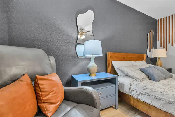 a bedroom with a bed and wooden floor