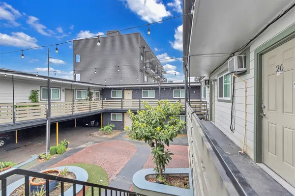 a view of a house with sitting area and a yard