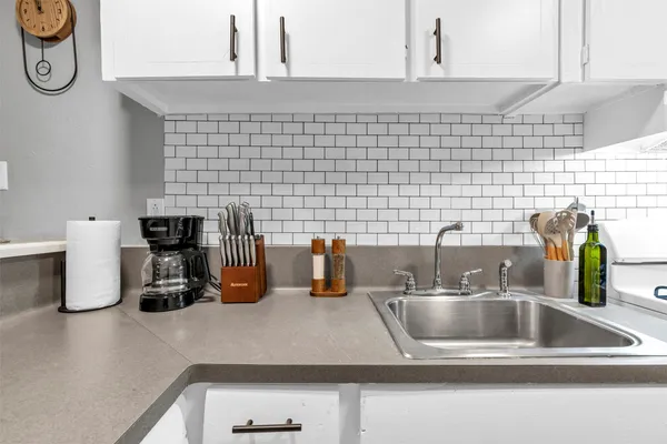 a kitchen with a sink and a granite counter tops