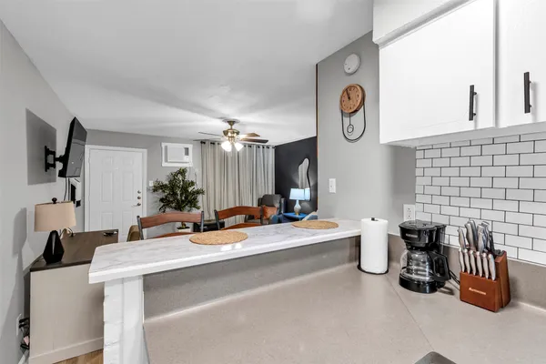 a room with a chandelier furniture and a large window