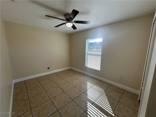 a view of a livingroom with a ceiling fan and window