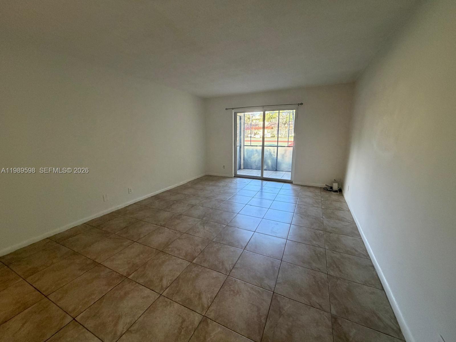 253 South Cypress Road, Unit 214 Pompano Beach, FL 33060 - Photo 6 of 25 an empty room with windows
