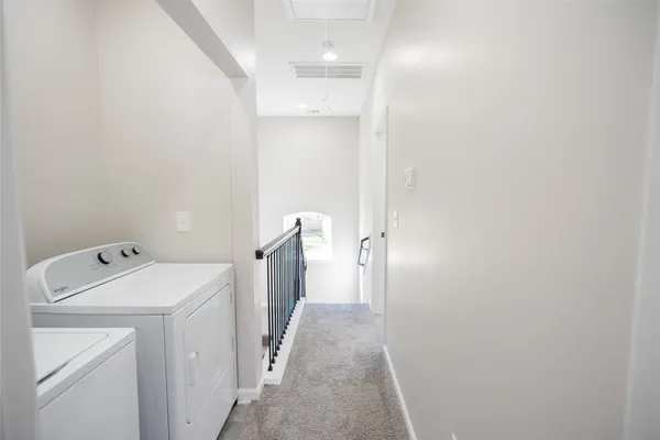 a view of a bathroom with a washer and dryer
