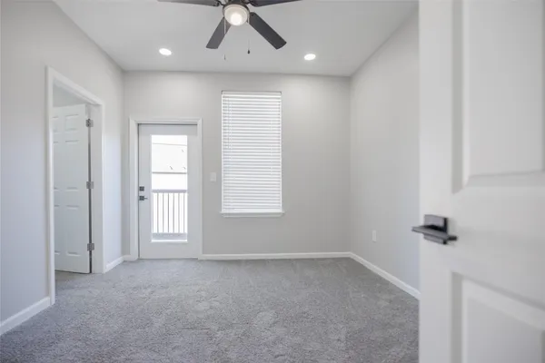 an empty room with windows and cabinet