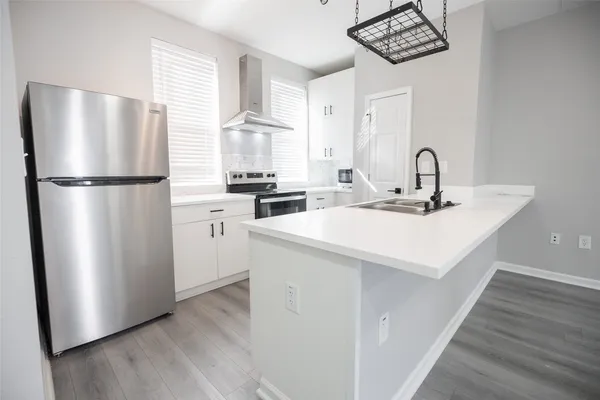 a kitchen with stainless steel appliances a refrigerator a sink a stove a microwave and island