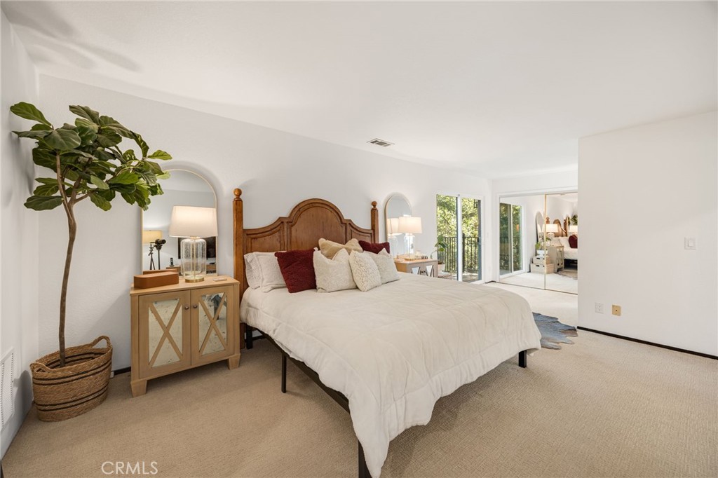 48980 De Luz Road Temecula, CA 92590 - Photo 32 of 50 a bedroom with a bed and a chandelier