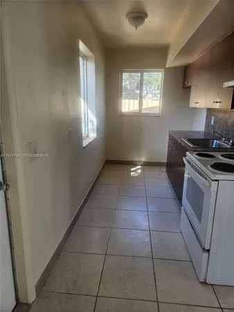 a kitchen with a stove a sink and a refrigerator
