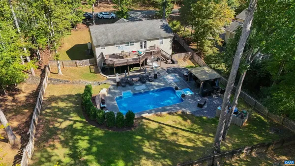 an aerial view of a house with garden space and street view