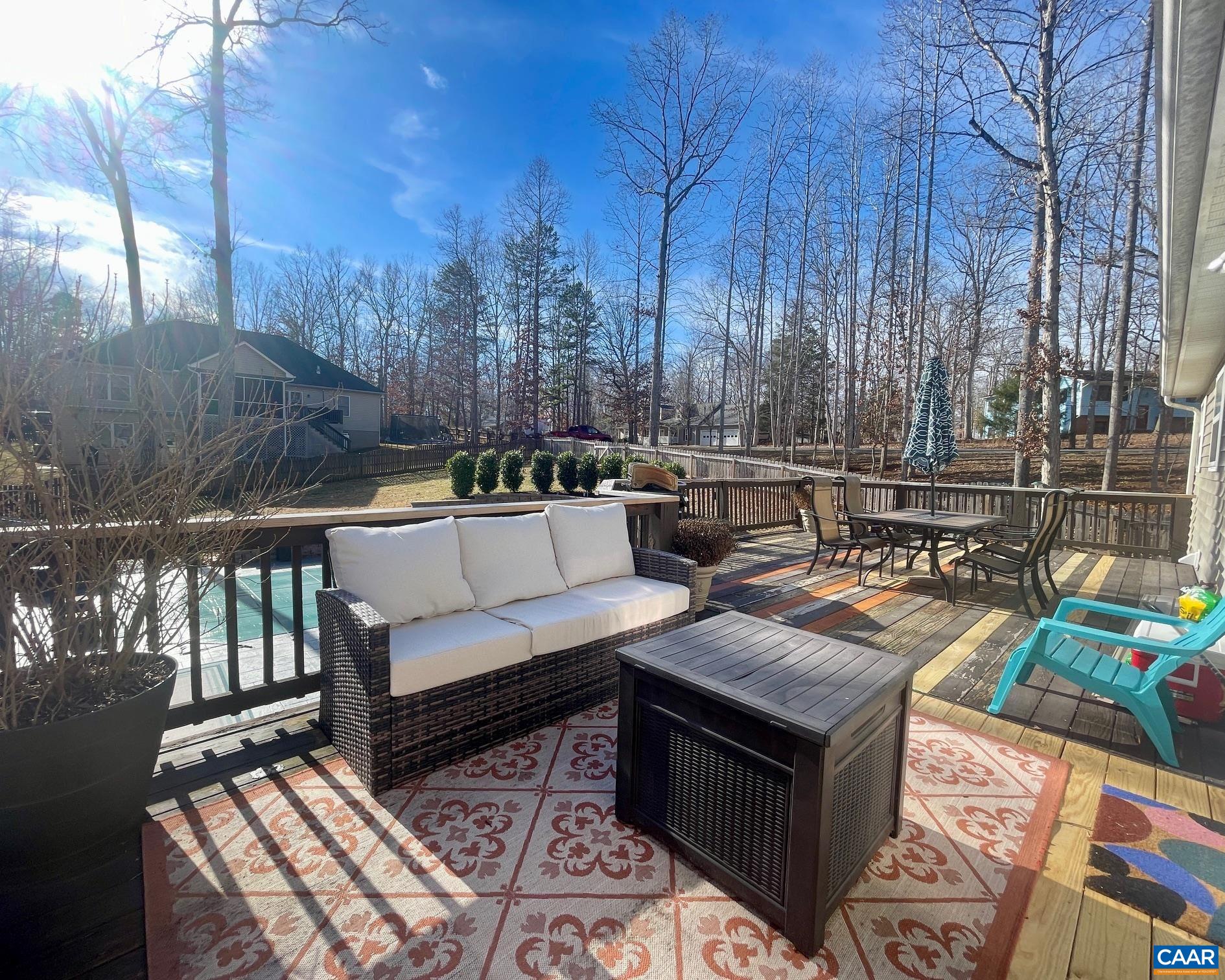 31 Laguna Road Palmyra, VA 22963 - Photo 12 of 39 a view of a patio with couches and table and chairs with wooden floor and fence