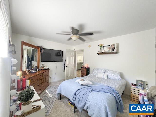 31 Laguna Road Palmyra, VA 22963 - Photo 17 of 39 a bedroom with a bed a ceiling fan and a large window