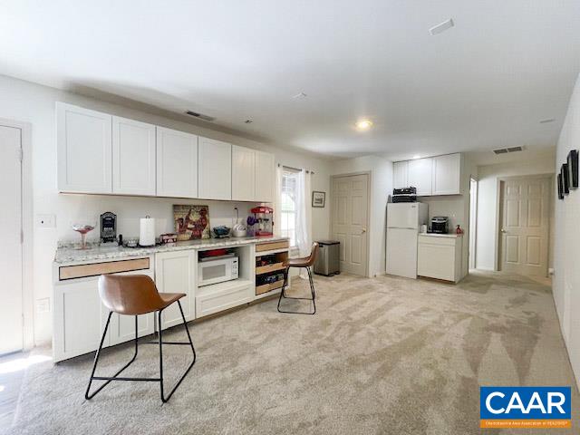31 Laguna Road Palmyra, VA 22963 - Photo 22 of 39 a kitchen with a refrigerator and white cabinets