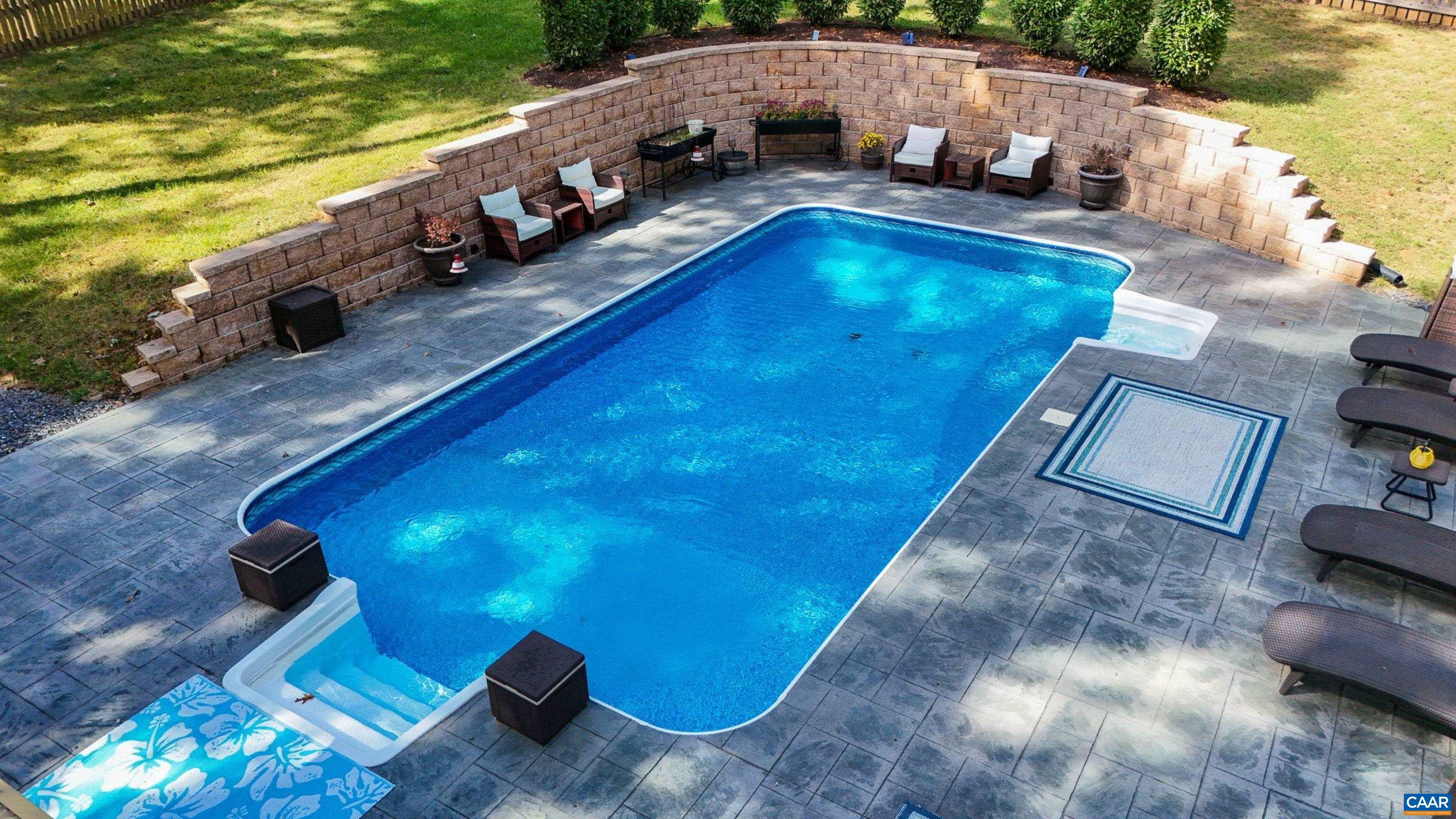 31 Laguna Road Palmyra, VA 22963 - Photo 35 of 39 a view of a swimming pool with lawn chairs under an umbrella