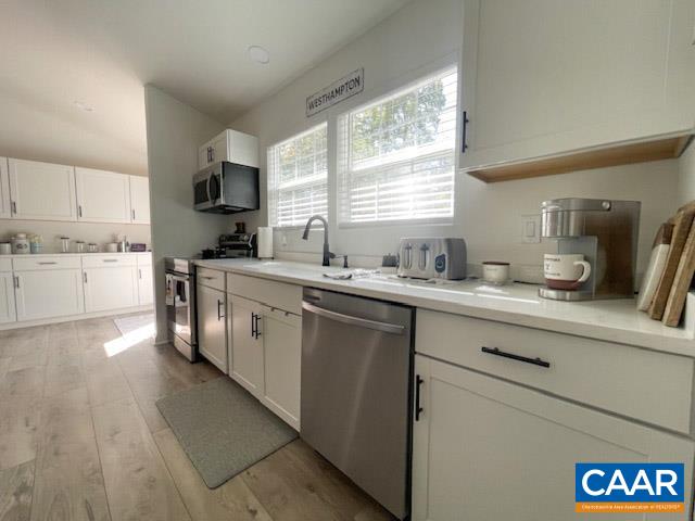 31 Laguna Road Palmyra, VA 22963 - Photo 10 of 39 a kitchen with kitchen island granite countertop a sink cabinets and window