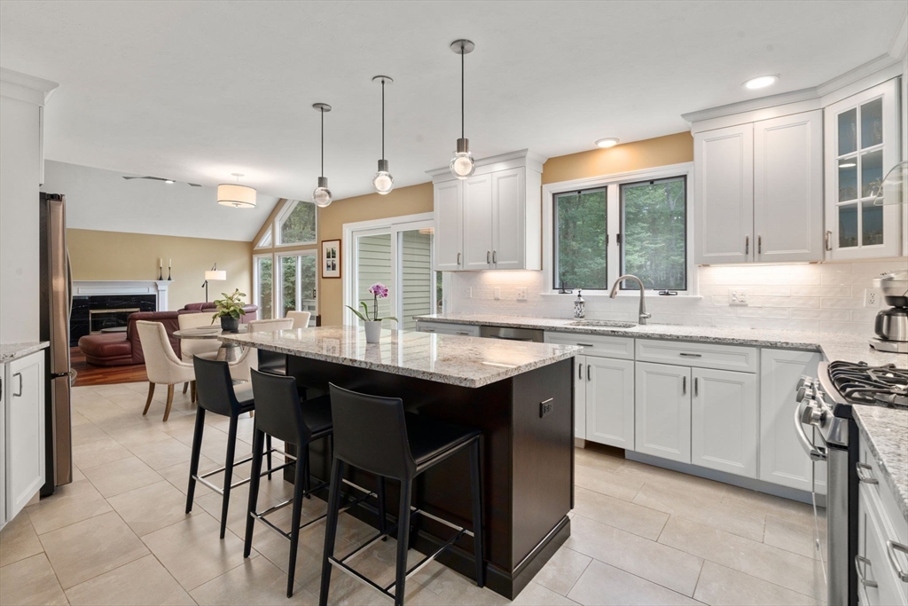 12 Thorny Lea Road Sharon, MA 02067 - Photo 6 of 29 a kitchen with center island table and chairs
