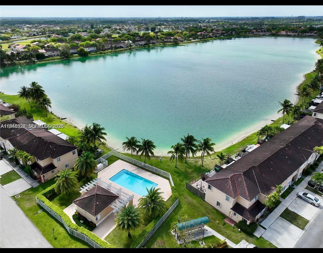 an aerial view of a house with a lake view