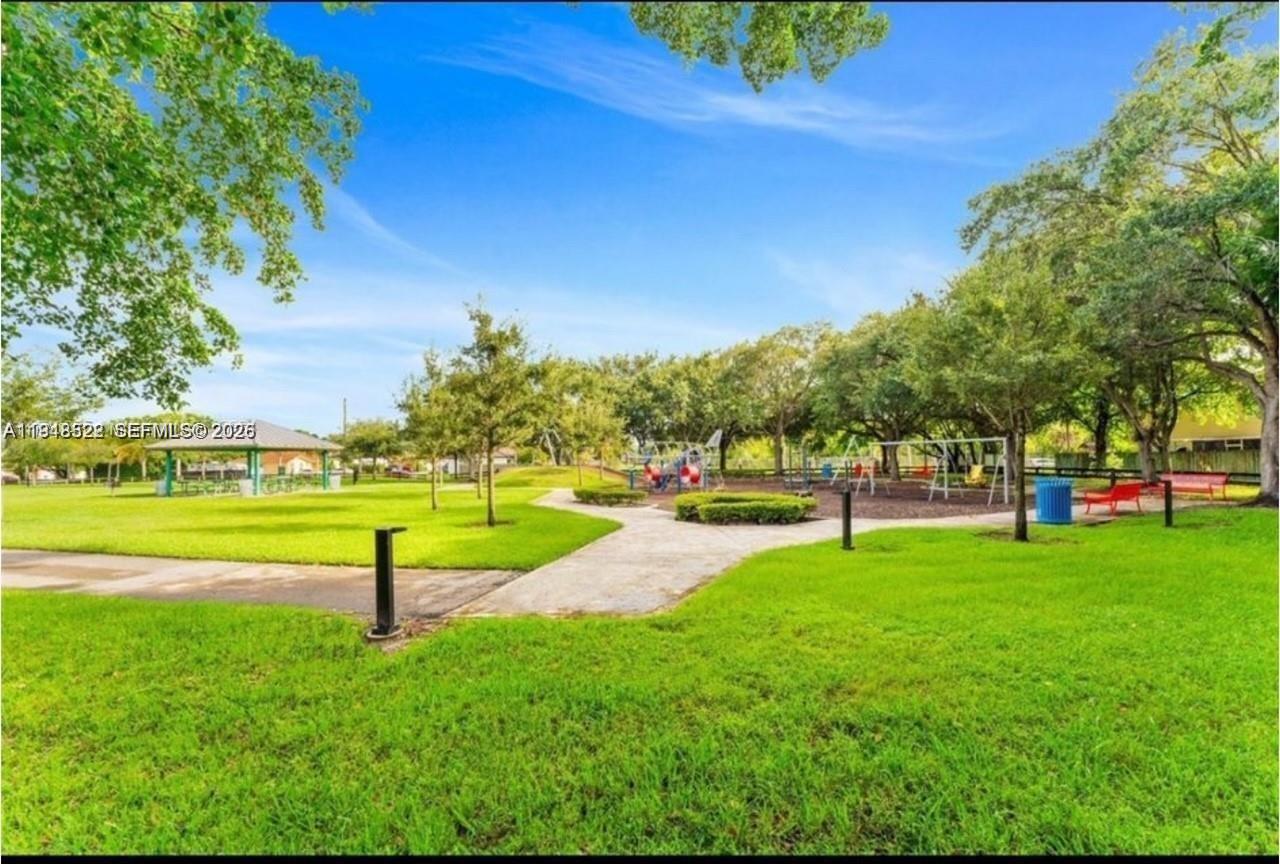 14085 Southwest 179th Terrace Miami, FL 33177 - Photo 2 of 24 a view of a park with trees and grass