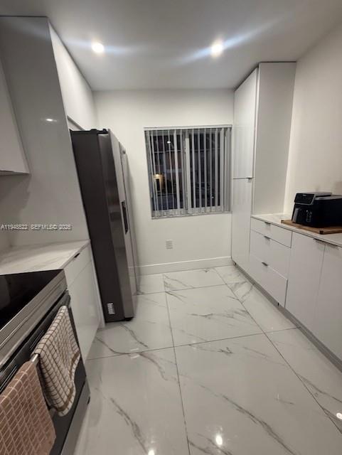 14085 Southwest 179th Terrace Miami, FL 33177 - Photo 5 of 24 a view of a refrigerator a washer and dryer