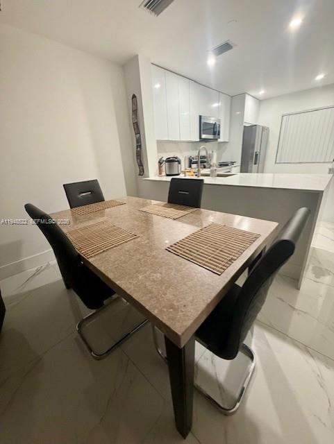 14085 Southwest 179th Terrace Miami, FL 33177 - Photo 9 of 24 a kitchen with kitchen island wooden cabinets and refrigerator