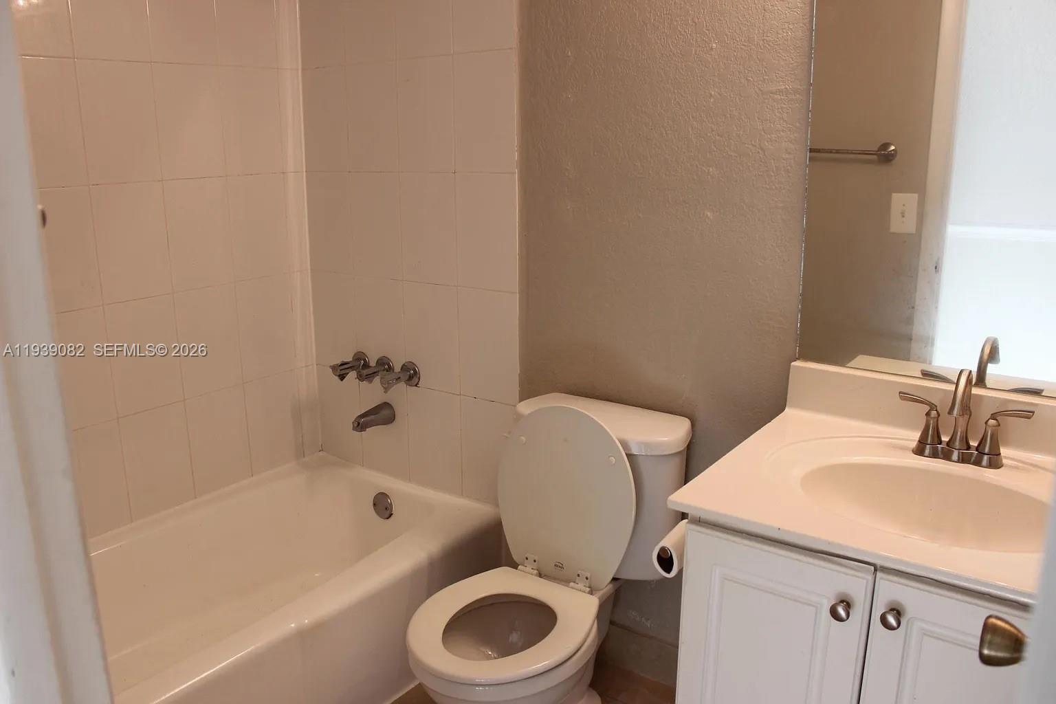 9441 Southwest 76th Street, Unit V33 Miami, FL 33173 - Photo 13 of 21 a bathroom with a sink a toilet and bathtub