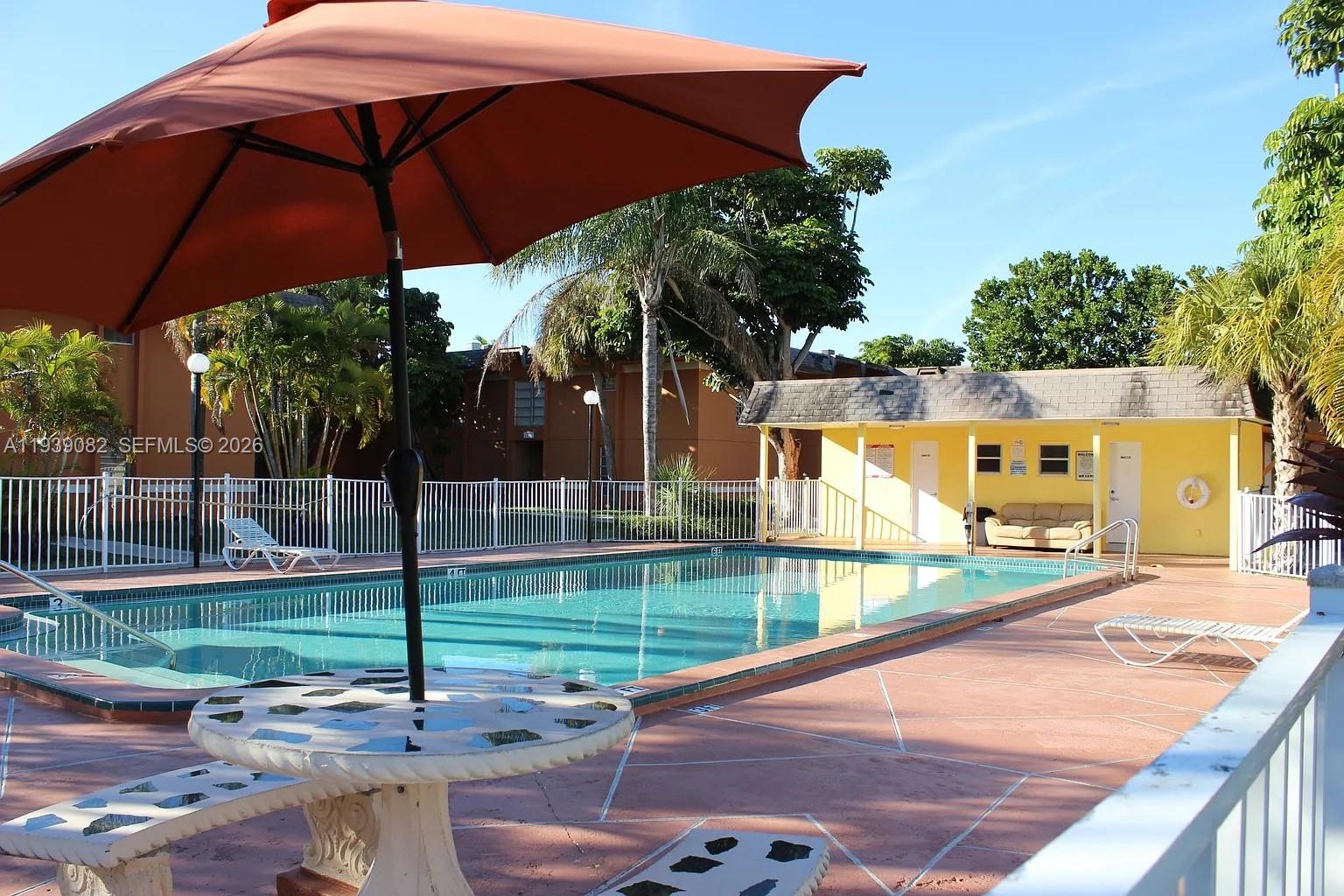 9441 Southwest 76th Street, Unit V33 Miami, FL 33173 - Photo 19 of 21 a view of a backyard with under an umbrella
