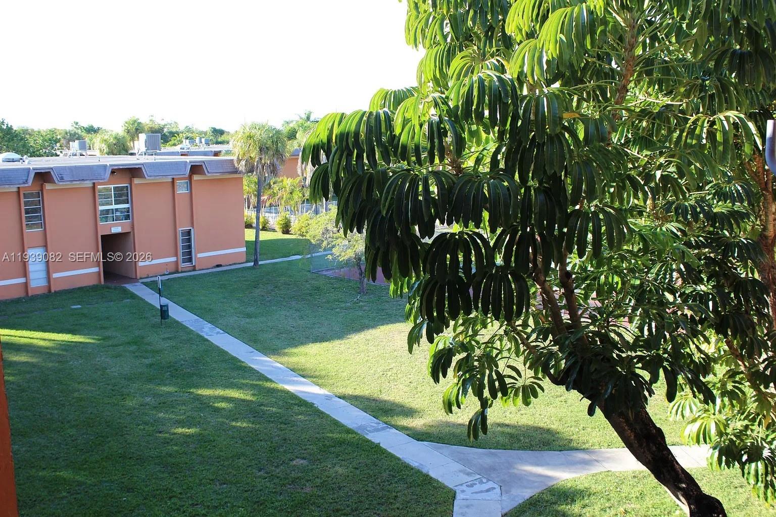 9441 Southwest 76th Street, Unit V33 Miami, FL 33173 - Photo 20 of 21 a view of a garden with a tree