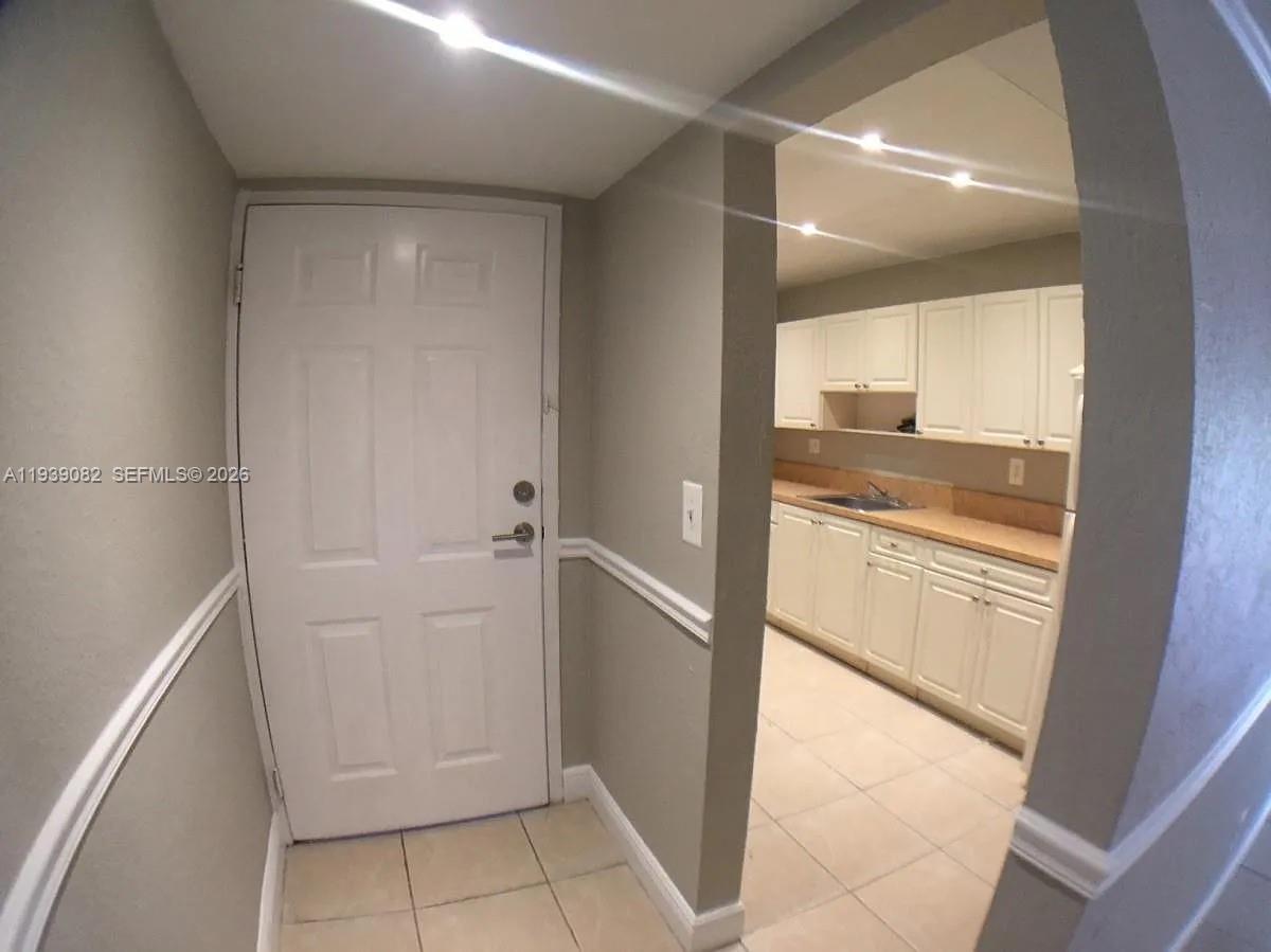 9441 Southwest 76th Street, Unit V33 Miami, FL 33173 - Photo 2 of 21 a bathroom with a granite countertop sink and a mirror
