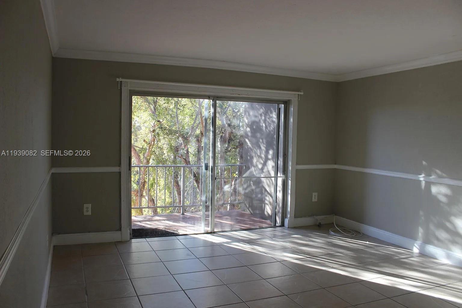 9441 Southwest 76th Street, Unit V33 Miami, FL 33173 - Photo 4 of 21 a view of empty room with wooden floor and fan