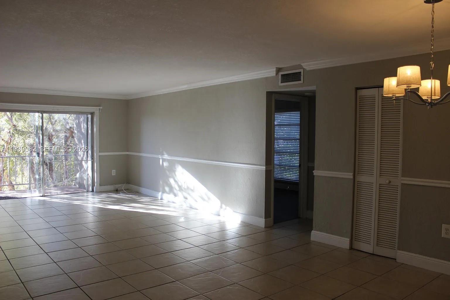 9441 Southwest 76th Street, Unit V33 Miami, FL 33173 - Photo 8 of 21 a view of empty room with wooden floor and fan