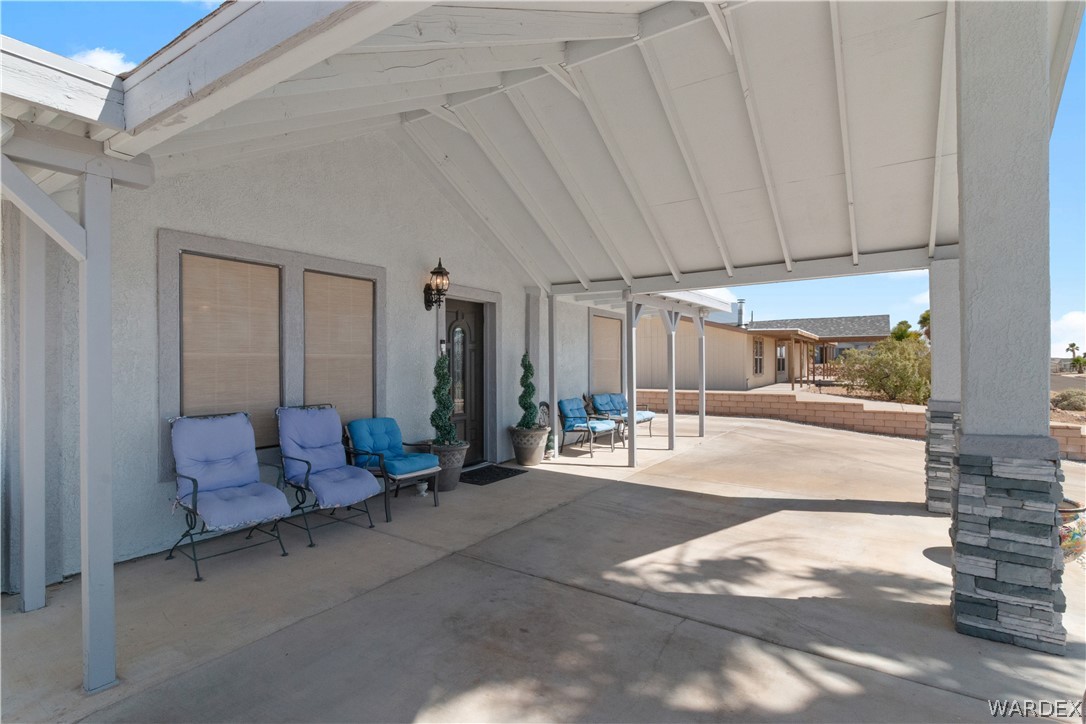 784 Pegasus Ranch Road Bullhead City, AZ 86429 - Photo 63 of 100 Covered concrete carport providing shade and direct access to the entry