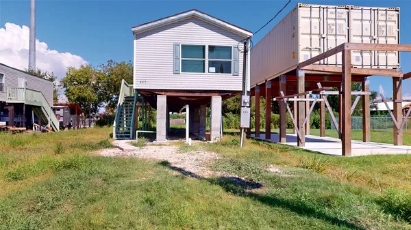 a view of a house with a yard and porch