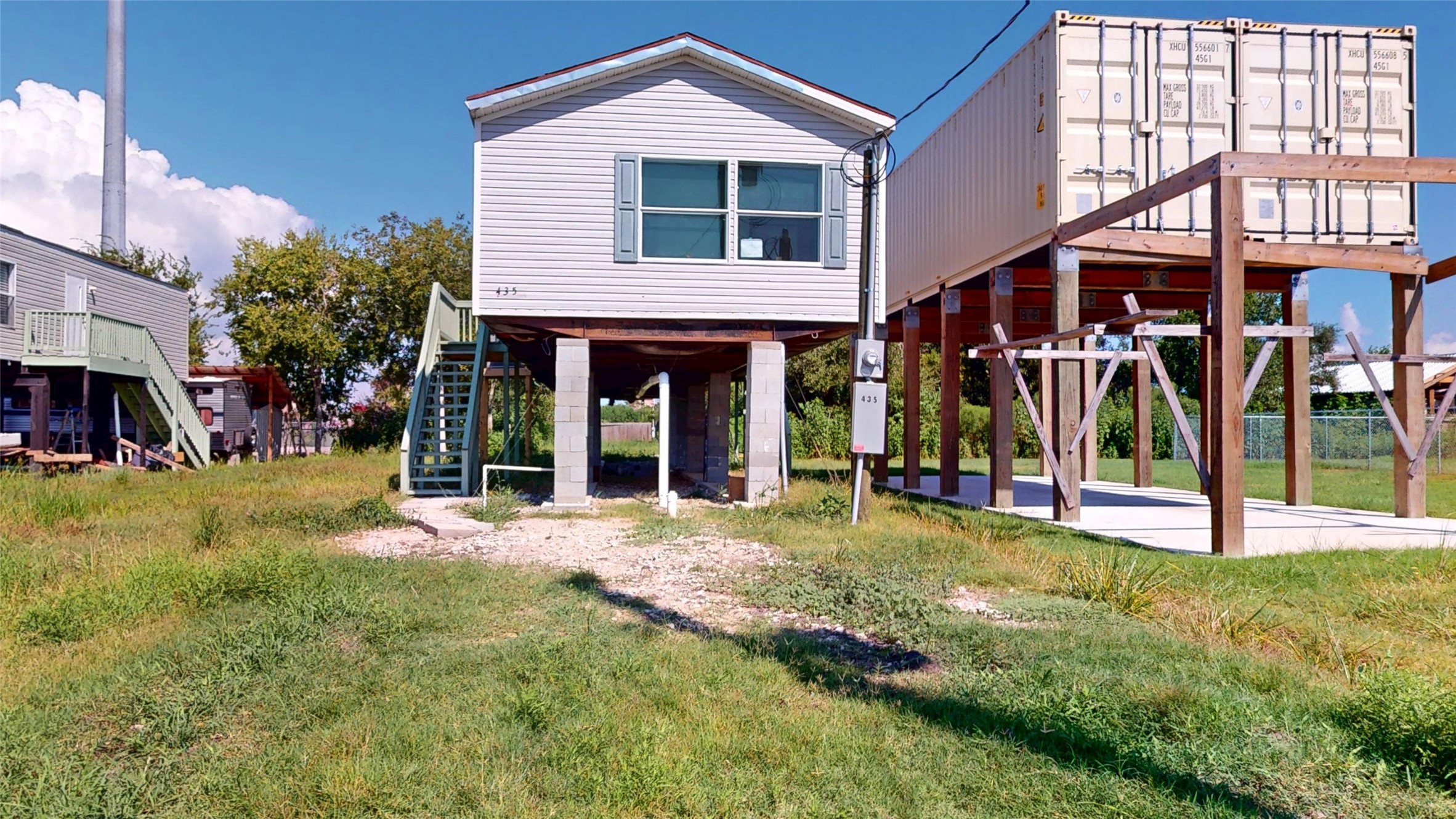 a view of a house with a yard and porch