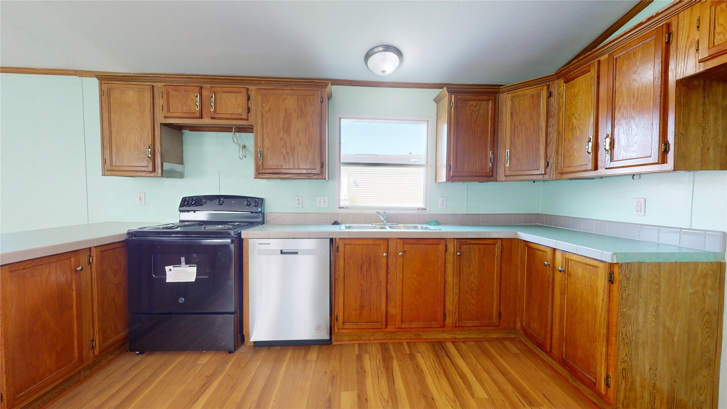435 16th Street San Leon, TX 77539 - Photo 16 of 44 a kitchen with granite countertop wooden cabinets a sink and dishwasher