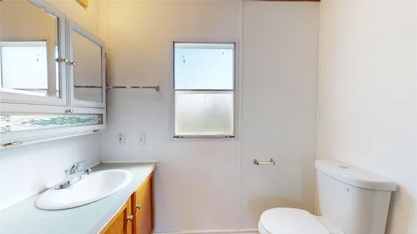 a bathroom with a sink toilet and mirror