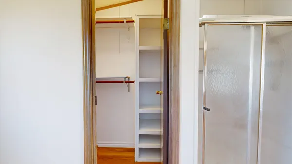 a bathroom with a glass shower door