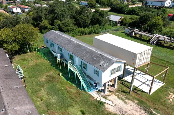 an aerial view of a house with swimming pool patio and outdoor seating