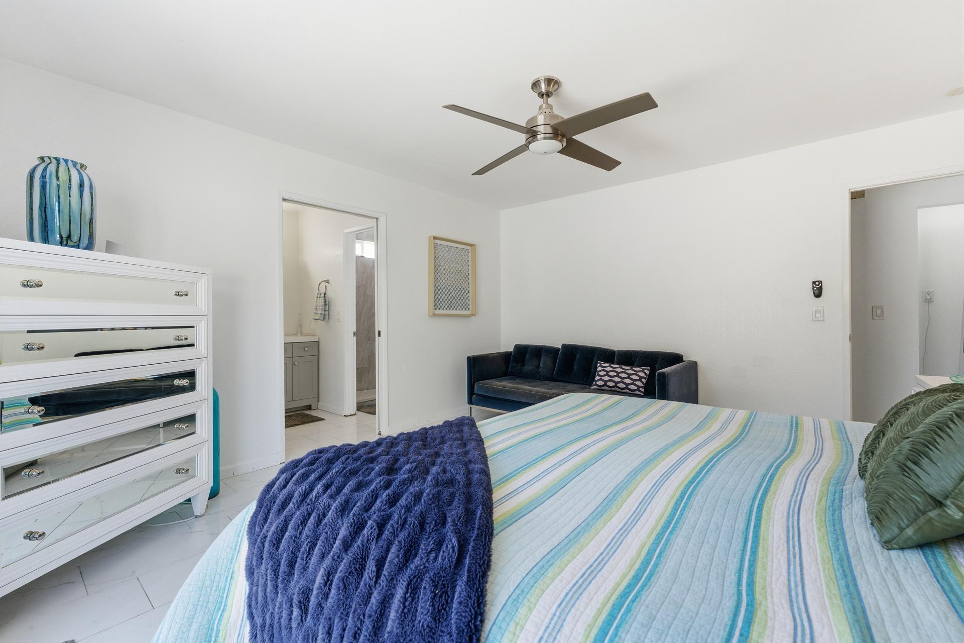 67220 Quijo Road Cathedral City, CA 92234 - Photo 18 of 26 a bedroom with a bed and a chandelier