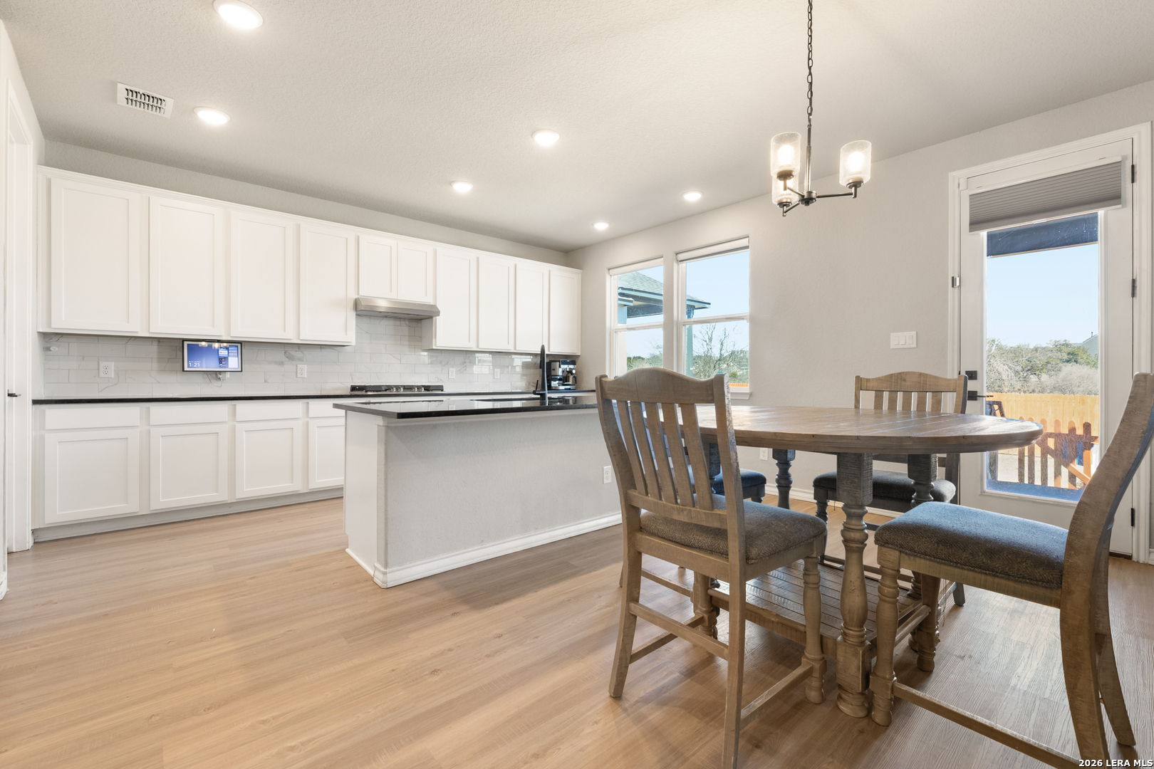 229 Jereth Crossing Castroville, TX 78009 - Photo 14 of 41 a view of kitchen with cabinets table and chairs