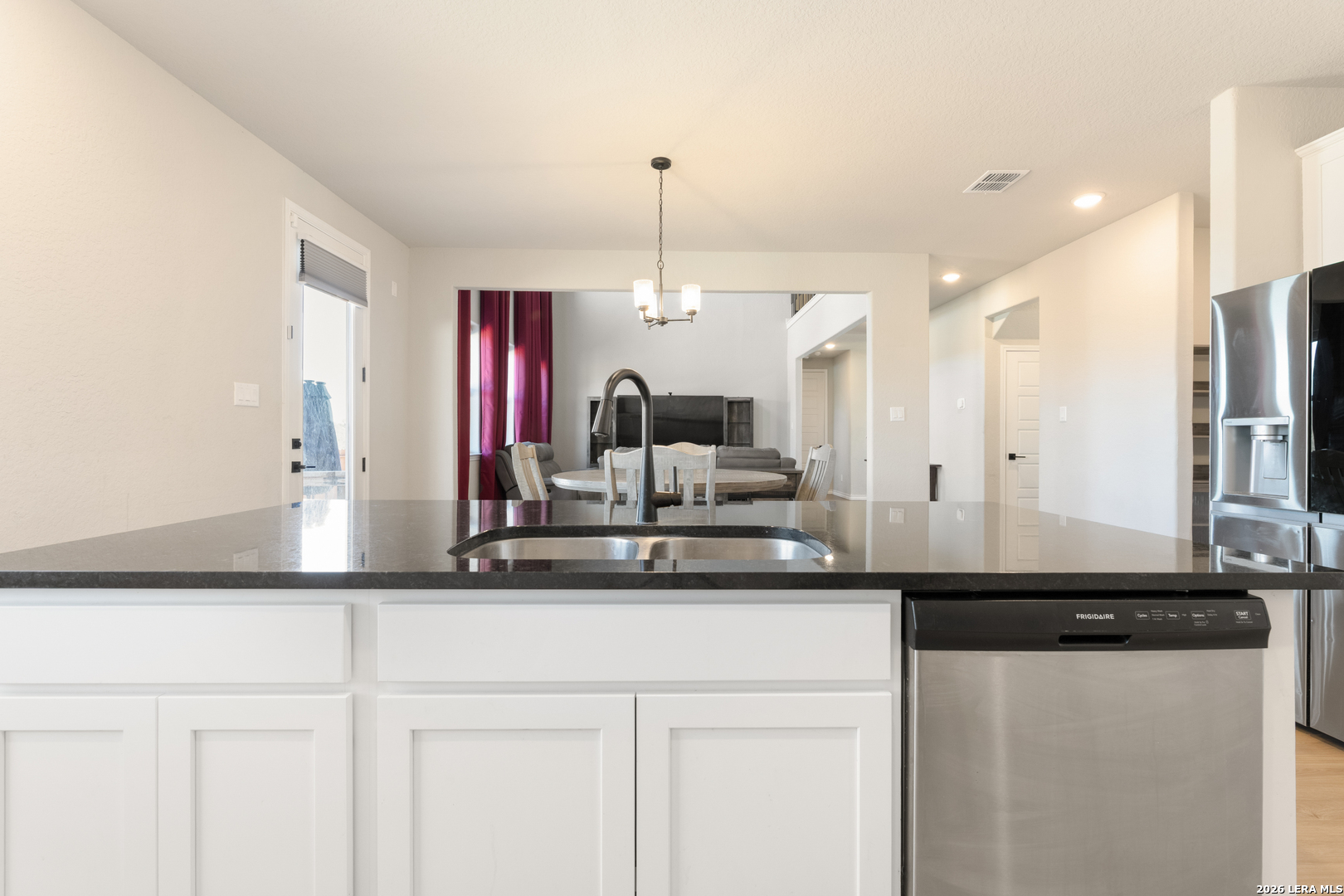 229 Jereth Crossing Castroville, TX 78009 - Photo 15 of 41 a kitchen with a sink and refrigerator