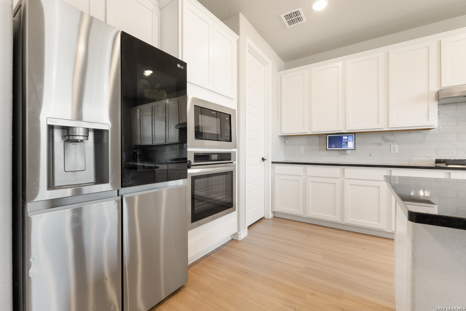 229 Jereth Crossing Castroville, TX 78009 - Photo 19 of 41 a kitchen with stainless steel appliances granite countertop a refrigerator and a stove top oven