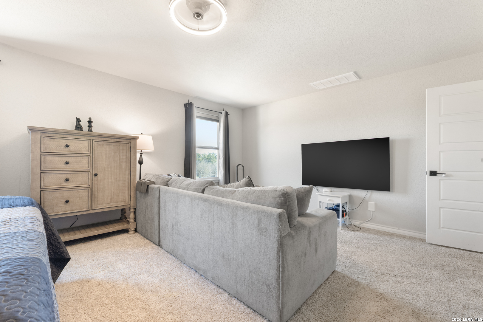 229 Jereth Crossing Castroville, TX 78009 - Photo 27 of 41 a living room with furniture and a flat screen tv