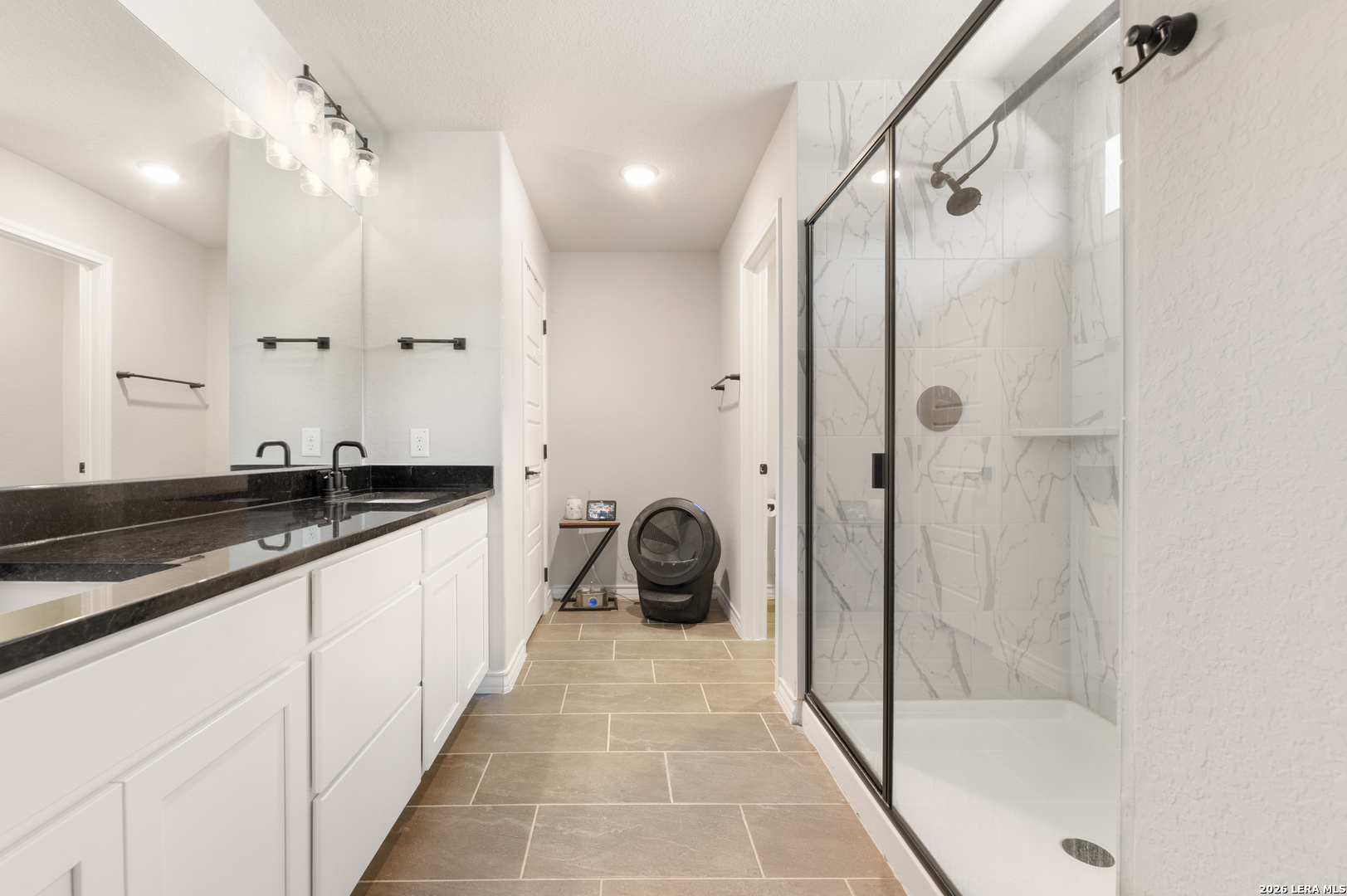 229 Jereth Crossing Castroville, TX 78009 - Photo 30 of 41 a large bathroom with a granite countertop sink a mirror a bathtub and shower