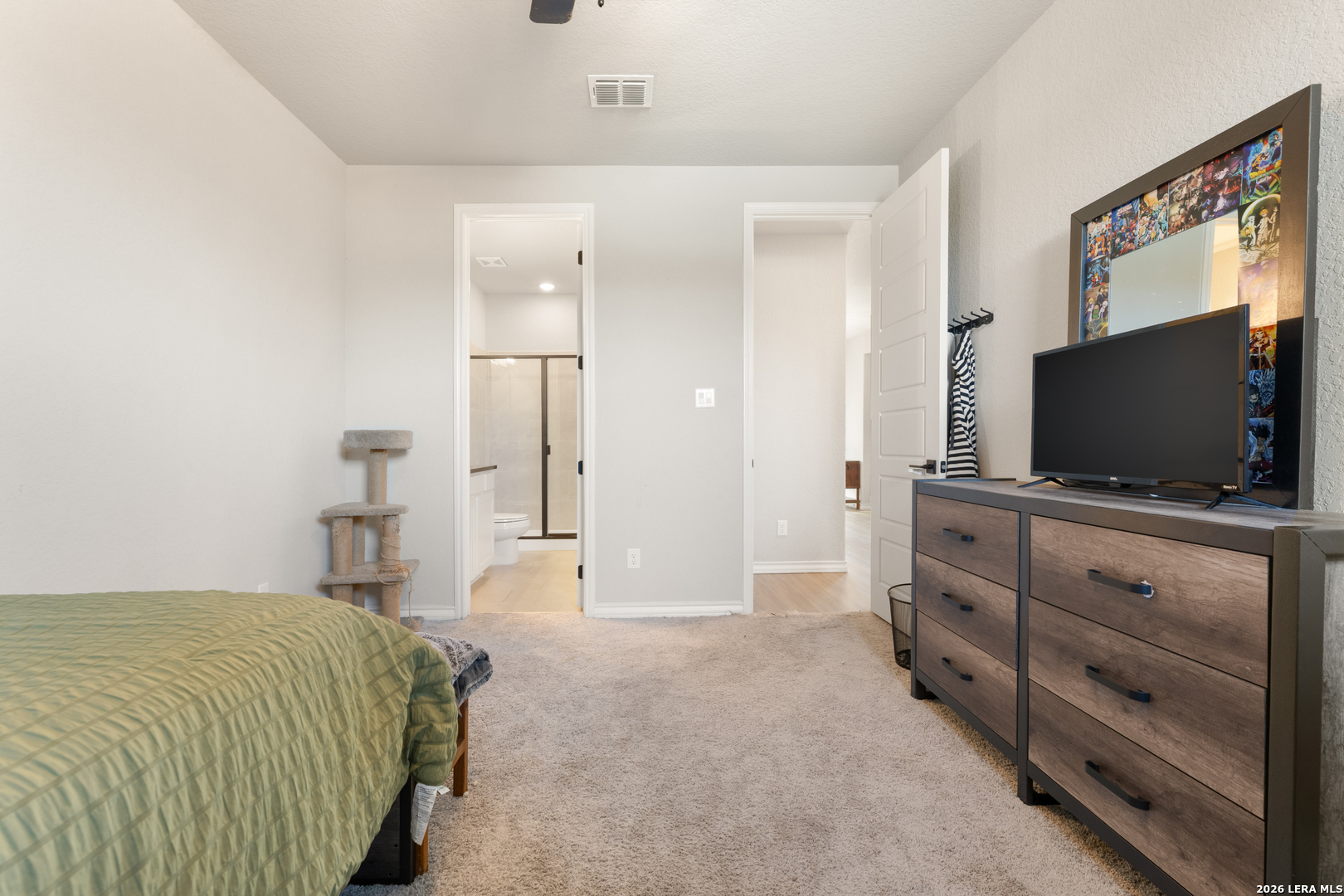 229 Jereth Crossing Castroville, TX 78009 - Photo 31 of 41 a bedroom with a bed and a flat screen tv