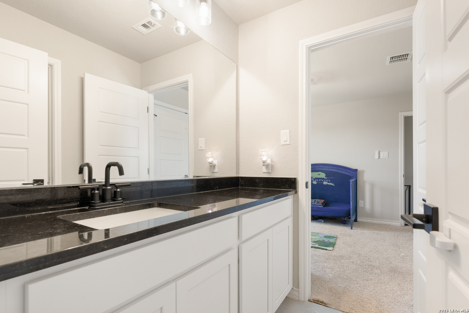 229 Jereth Crossing Castroville, TX 78009 - Photo 35 of 41 a bathroom with a sink and a mirror